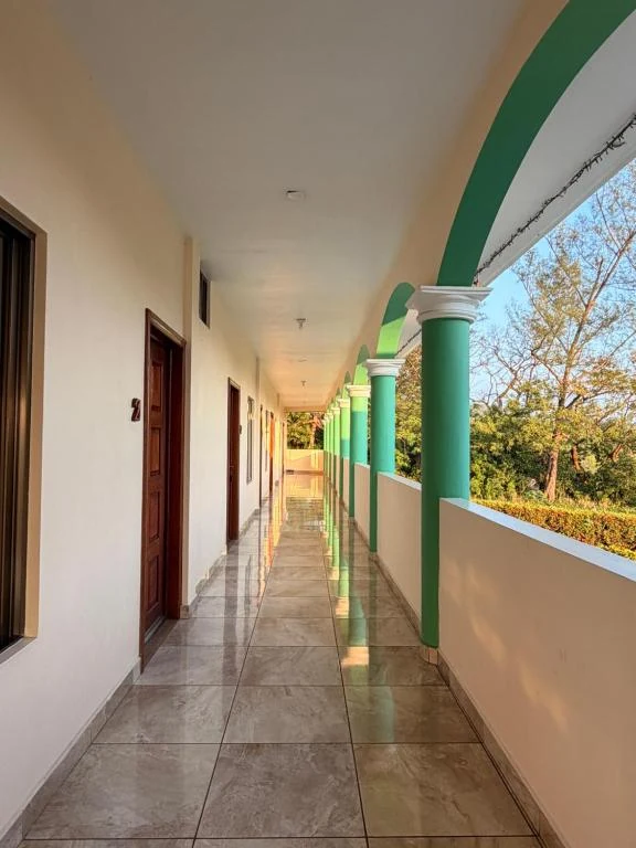 Open-air walkway overlooking the hotel garden